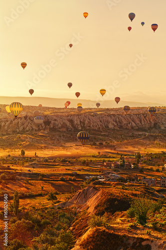Balloons in gentle soft light over Cappadocia