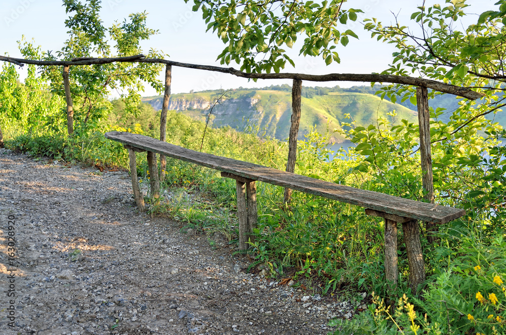 Wooden bench in the background of a valley