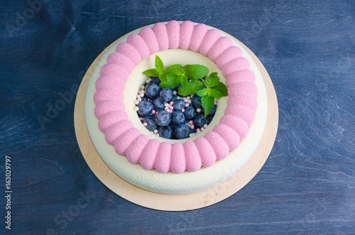 Chocolate velour cake with blueberries and basil leaves