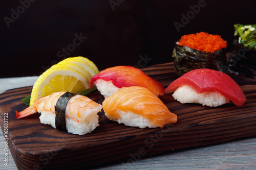 Fresh Sushi set with salmon, prawns and tuna. Traditional Japanese cuisine.