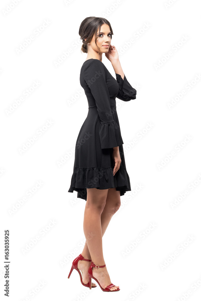Side view of passionate Hispanic dancer relaxing and touching hair looking at camera. Full body length portrait isolated on white background. Side view of passionate Hispanic dancer relaxing and touching hair looking at camera. Full body length portrait isolated on white background.