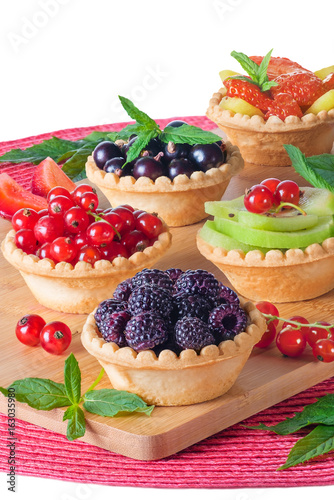 Tartlets with a stuffing of red currant, black currant, blackberry, strawberry, kiwi. Homemade summer healthy dessert.