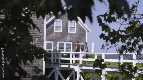 Group Of Friends Cross A Bridge, Ocean In Background photo