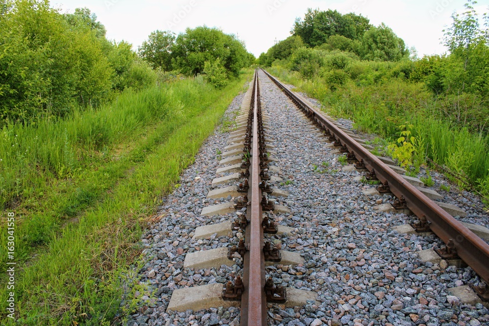 Obraz premium Rusty track rails. The railway track itself is new, the rails rust from time because there are no trains running through them.