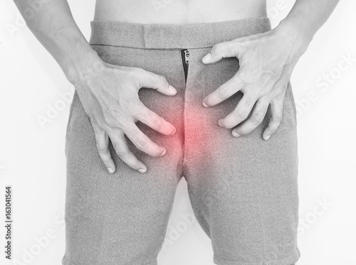 Fotografie Young man are scratching the crotch, itching crotch, Concept with healthcare and medicine