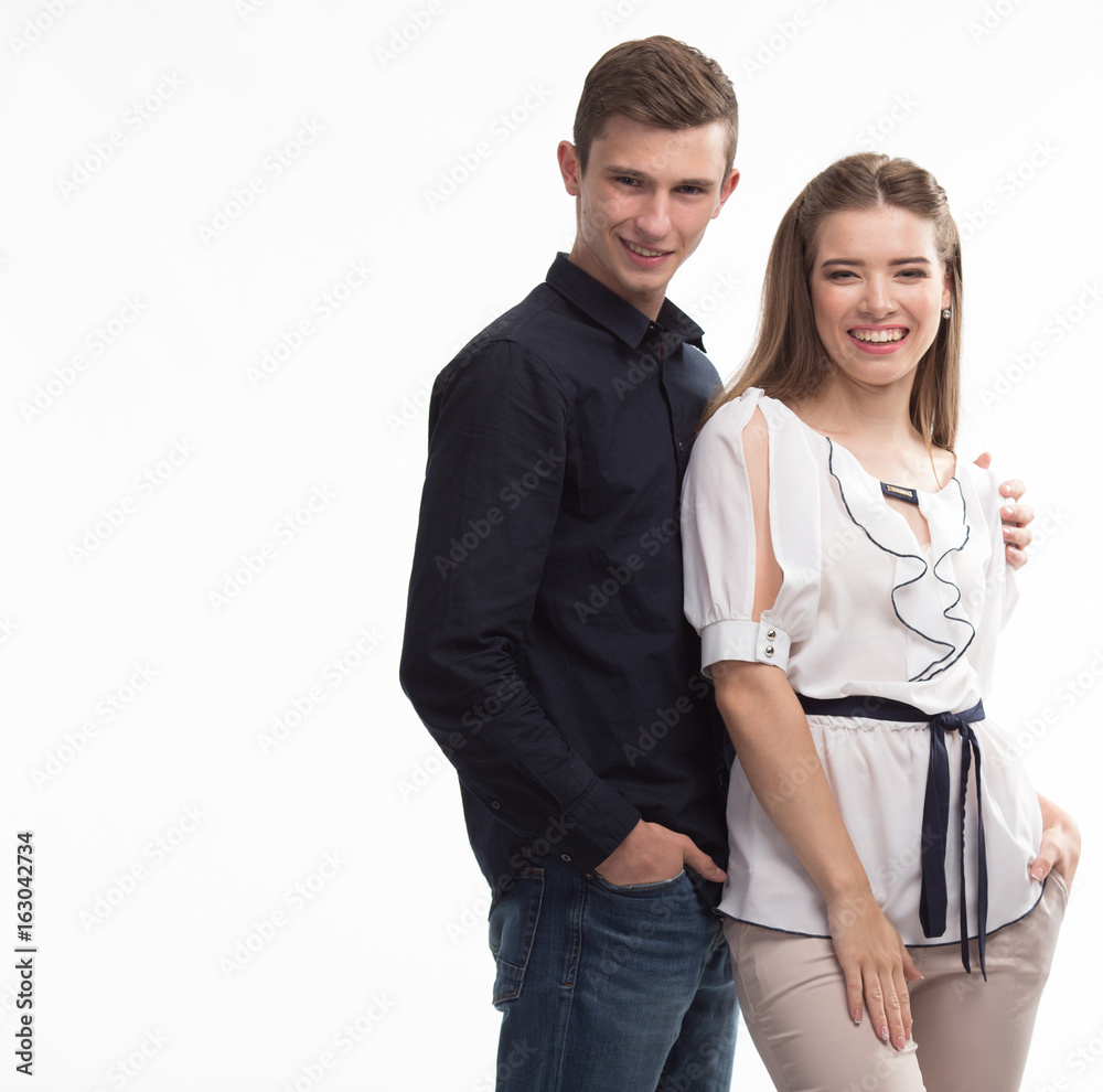 Young happy couple portrait of a confident businessman showing on a gray background. Ideal for banners, registration forms, presentation, landings, presenting concept.