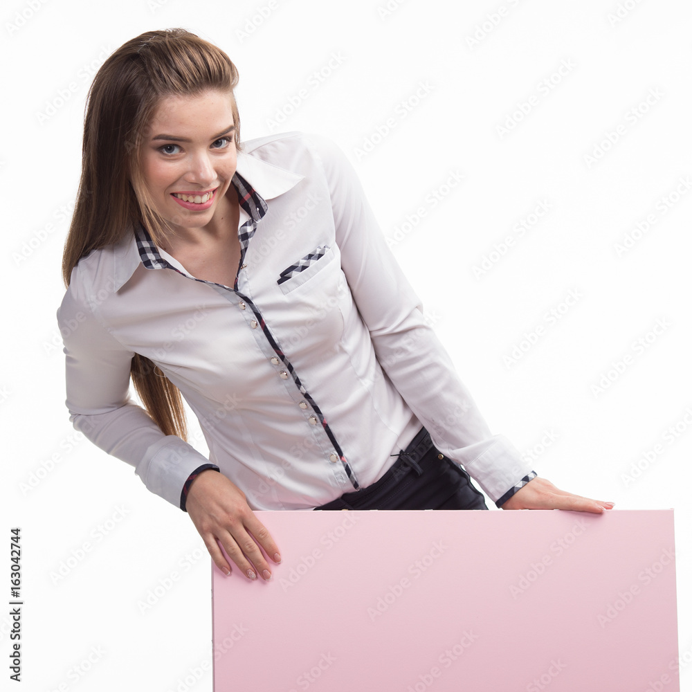 Young encouraged woman portrait of a confident businesswoman showing presentation, pointing placard pink background. Ideal for banners, registration forms, presentation, landings, presenting concept.. Young encouraged woman portrait of a confident businesswoman showing presentation, pointing placard pink background. Ideal for banners, registration forms, presentation, landings, presenting concept..