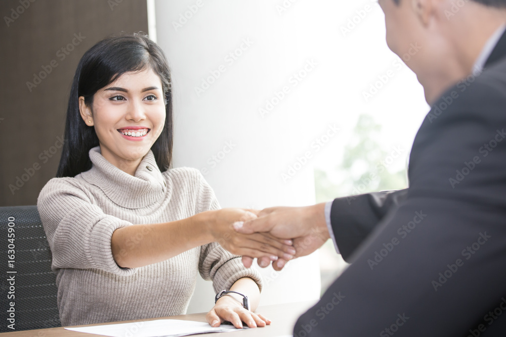 Asian businesspeople shaking hands greeting deal with each other at working place, acceptation concept. Asian businesspeople shaking hands greeting deal with each other at working place, acceptation concept.