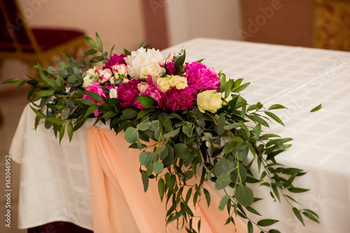 Wedding peony bouquet on table photo