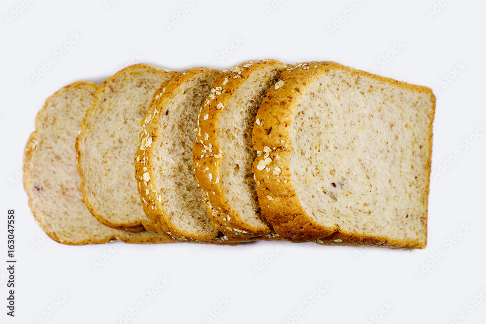 slices of whole wheat bread isolated on white background.