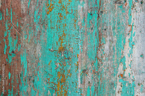 Cracked old wooden wall with textured paint, bright background close up © irissca