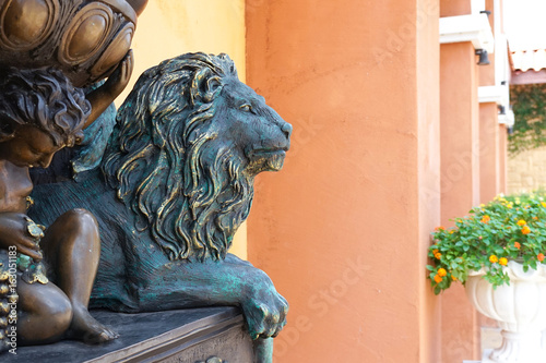 Wall Mural Bronze lion statue, selective focus, lion is looking away