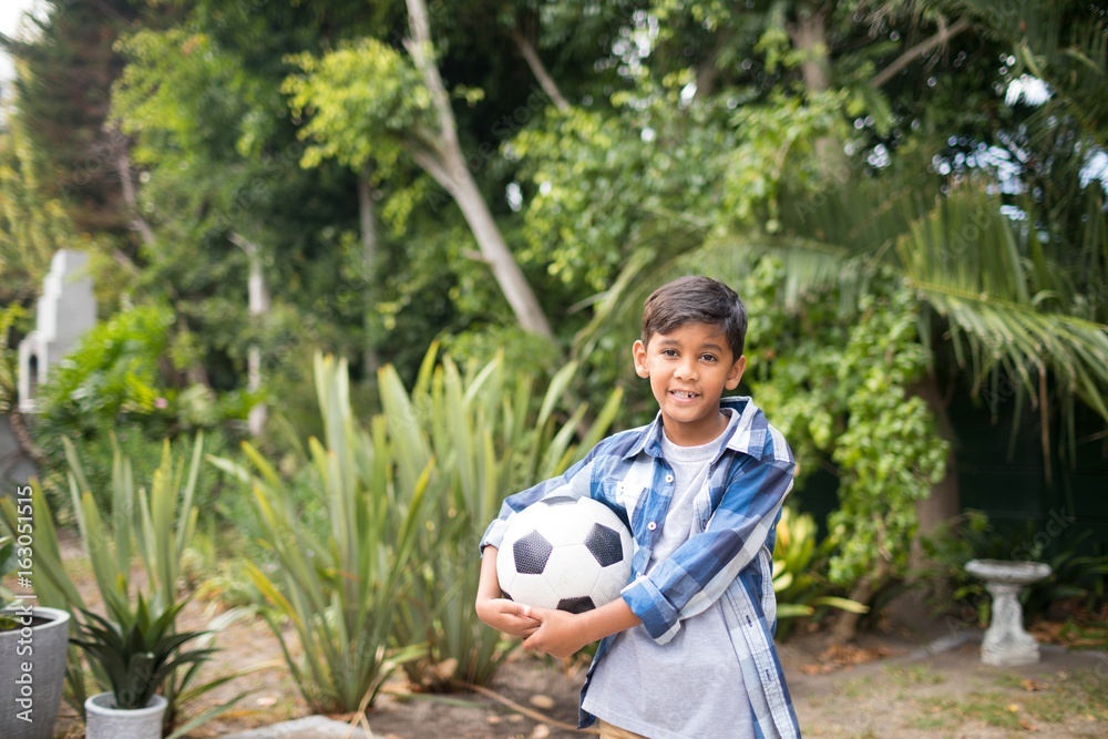 Portrait of boy holding soccer ball Portrait of boy holding soccer ball