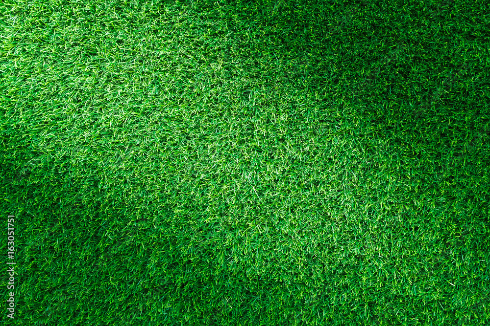 Obraz premium Artificial green grass texture for golf course, soccer field or sports background concept design.