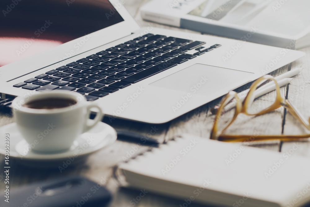Closeup of Workspace with Modern Creative Laptop, Cup of Coffee and Pencils. Horizontal with Copy Space. Closeup of Workspace with Modern Creative Laptop, Cup of Coffee and Pencils. Horizontal with Copy Space.