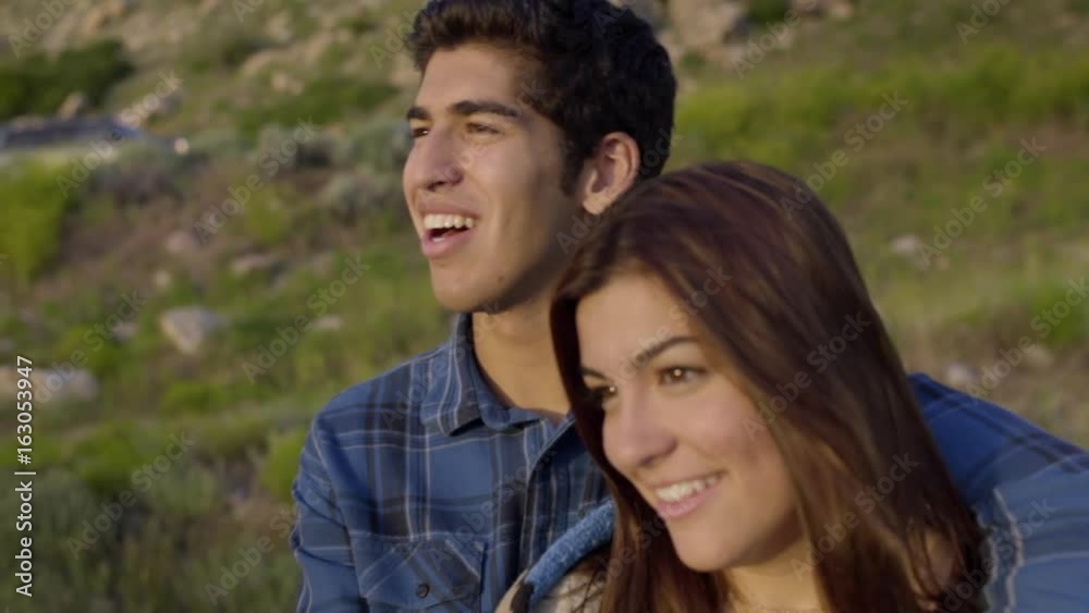 Young Couple Talk And Laugh, Watch The Sunset (Slow Motion) Young Couple Talk And Laugh, Watch The Sunset (Slow Motion)