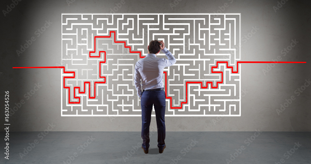 Businessman searching maze solution on a wall 3D rendering Businessman searching maze solution on a wall 3D rendering