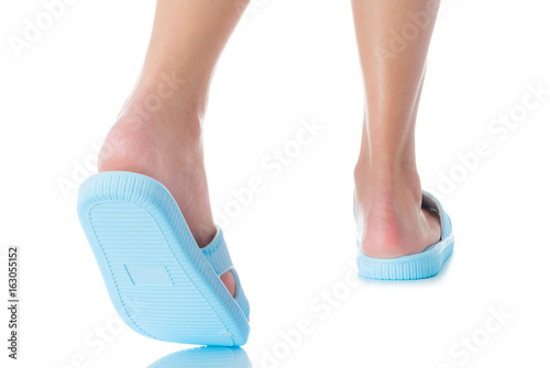 Woman feet wearing beautiful blue sandal step with back side on white background, Fashion woman concept.