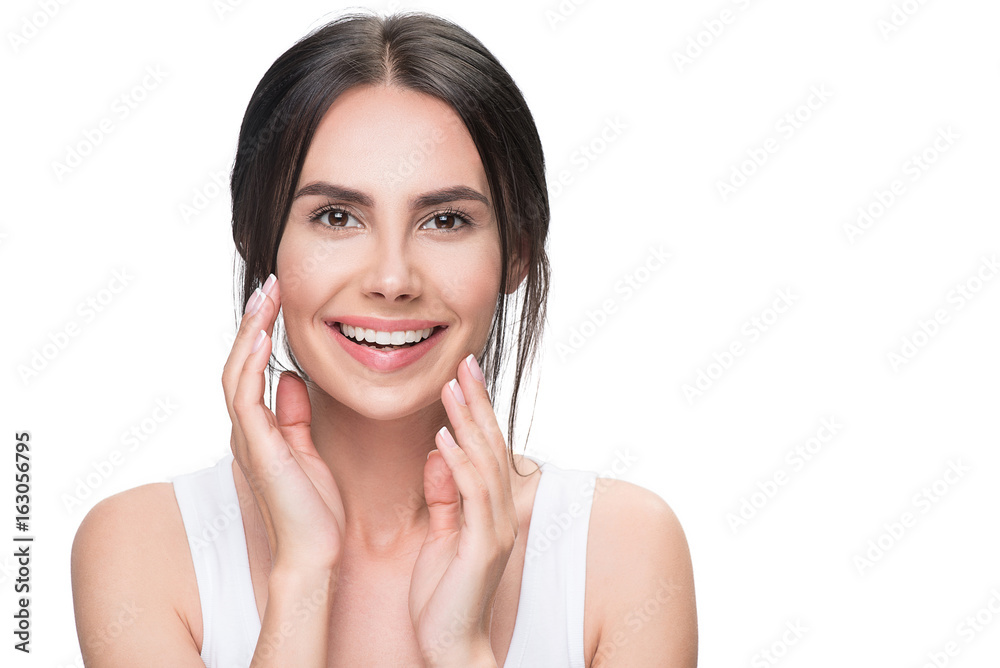 Joyful young woman touching her facial skin Joyful young woman touching her facial skin