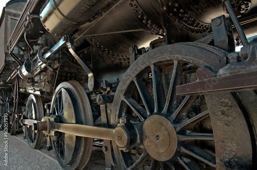 Locomotive: A large boiler rests on the heavy iron wheels of an old steam locomotive.
