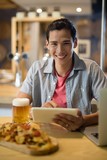 Man using digital tablet in restaurant