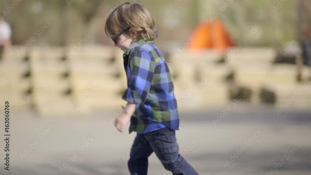 Happy And Independent Little Boy Runs Around Park Happy And Independent Little Boy Runs Around Park