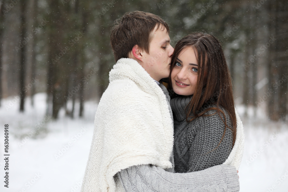 pair of lovers on a date winter afternoon in a snow blizzard pair of lovers on a date winter afternoon in a snow blizzard