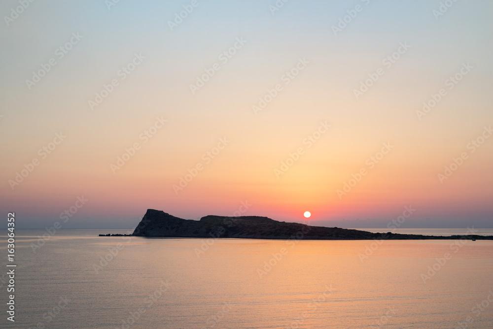 Sunrise on the beach, early morning in Kolokitha island, Crete, Greece