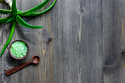 Skin care. Aloe vera leafs and spa salt on wooden background top view copyspace