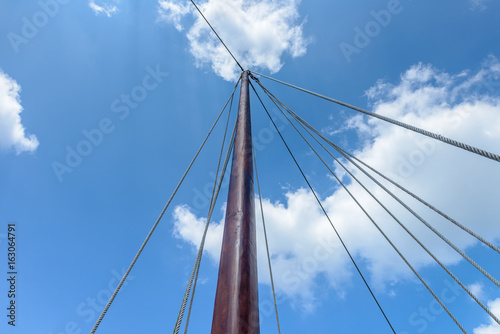 wooden sailing mast against the blue sky