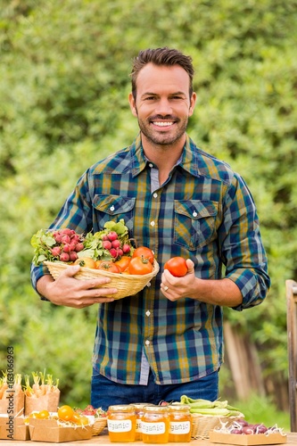 Portrait of young man selling organic vegetables