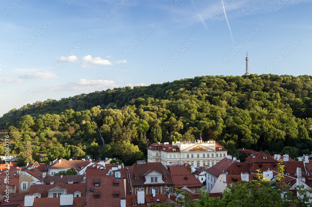 Fototapeta premium View of old buildings at the Mala Strana District (Lesser Town) and Petrin Lookout Tower at the Petrin Hill in Prague, Czech Republic.
