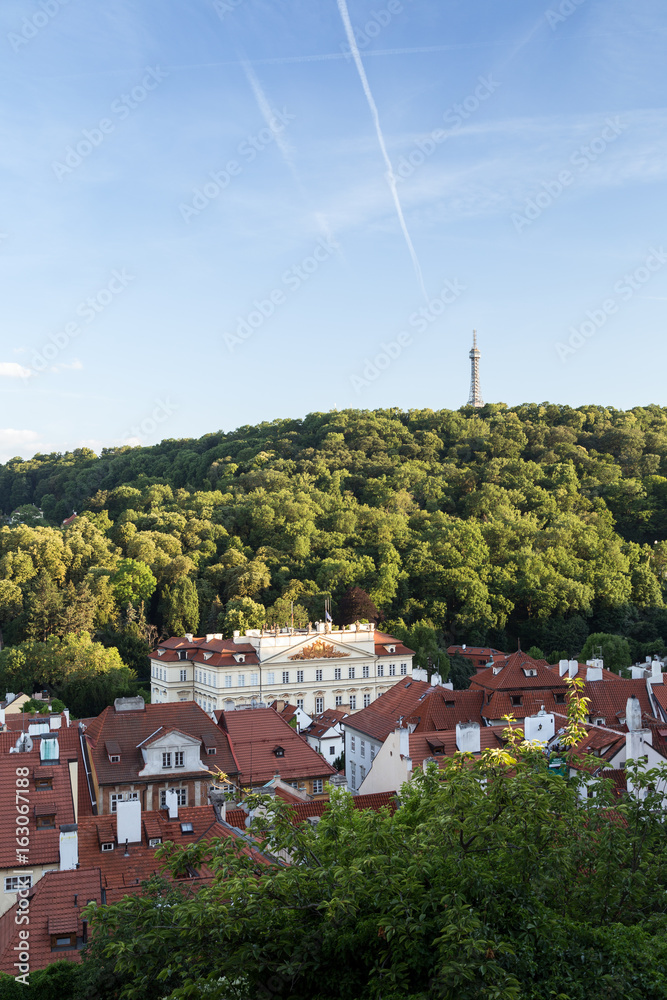 View of old buildings at the Mala Strana District (Lesser Town) and Petrin Lookout Tower at the Petrin Hill in Prague, Czech Republic. 