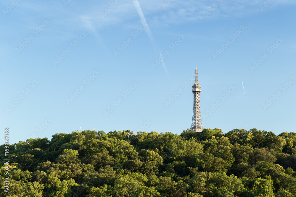 Obraz premium View of the Petrin Lookout Tower at the Petrin Hill in Prague, Czech Republic. Copy space.