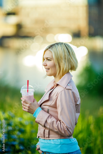 Girl with milkshake in park
