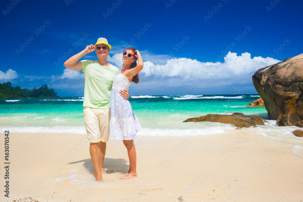 happy young couple having fun by the beach. Seychelles. Mahe Island. Baie Lazare beach happy young couple having fun by the beach. Seychelles. Mahe Island. Baie Lazare beach