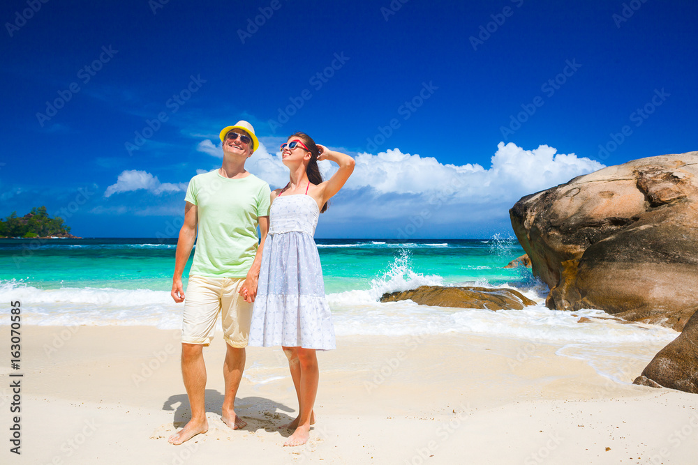 happy young couple having fun by the beach. Seychelles. Mahe Island. Baie Lazare beach happy young couple having fun by the beach. Seychelles. Mahe Island. Baie Lazare beach