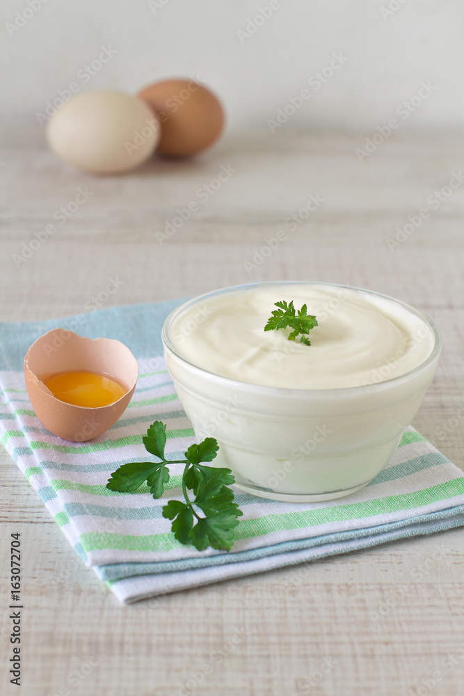 Homemade mayonnaise sauce in a bowl and ingredients Homemade mayonnaise sauce in a bowl and ingredients