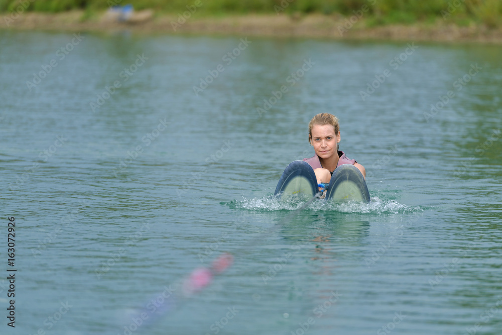 young woman study riding wakeboarding on a lake