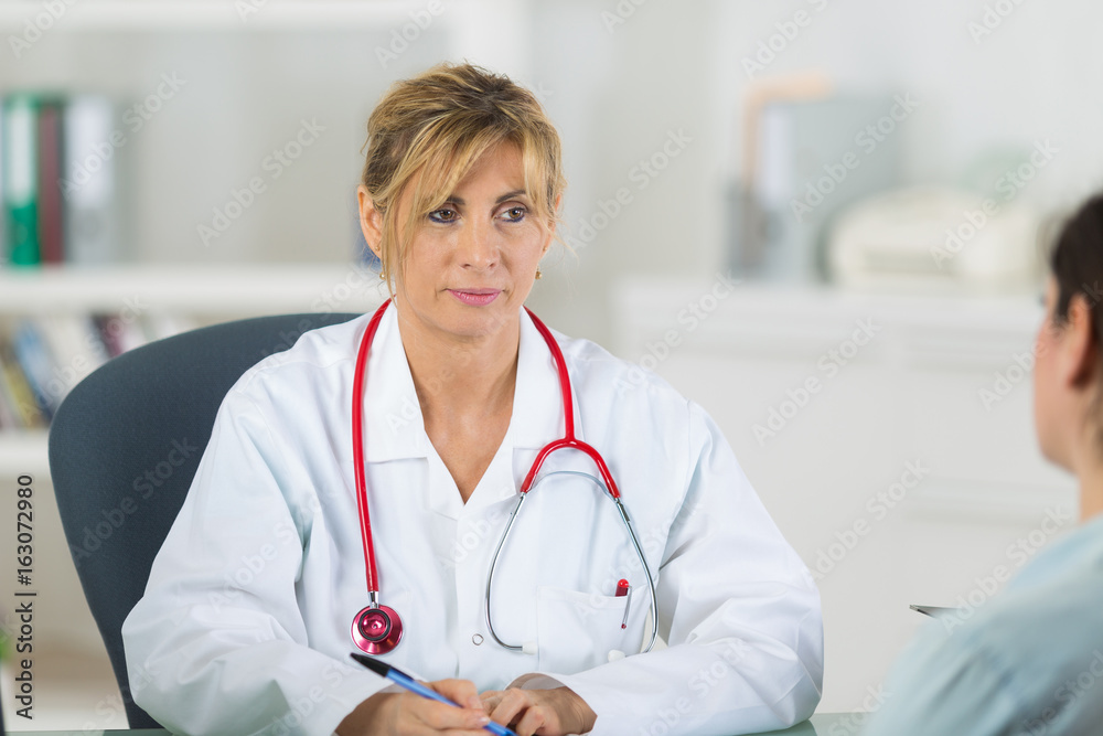female doctor standing in the hospital with patient female doctor standing in the hospital with patient