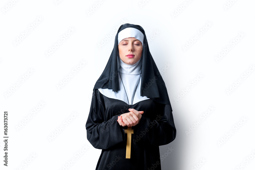 Young serious nun with cross Young serious nun with cross