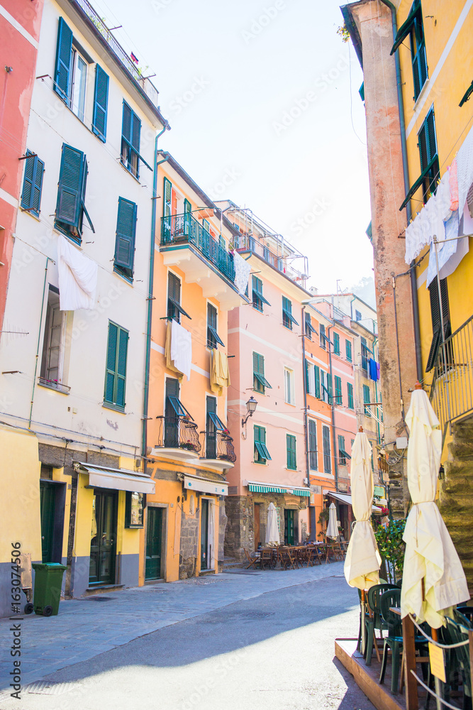 Obraz premium Old beautiful empty narrow streets with outdoor cafe in coastal village in Cinque Terre, Italy