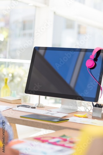 Computer with headphones at desk