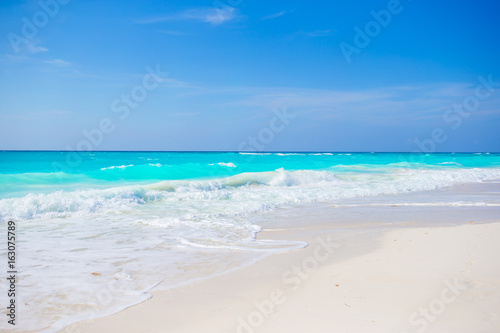 Idyllic tropical beach on Cuba in Caribbean with white sand  turquoise ocean water and blue sky