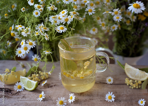 Cup of aromatic tea from fresh herbs - chamomile,linden and lemons.