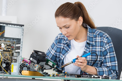 cute female engineer at home working on technology