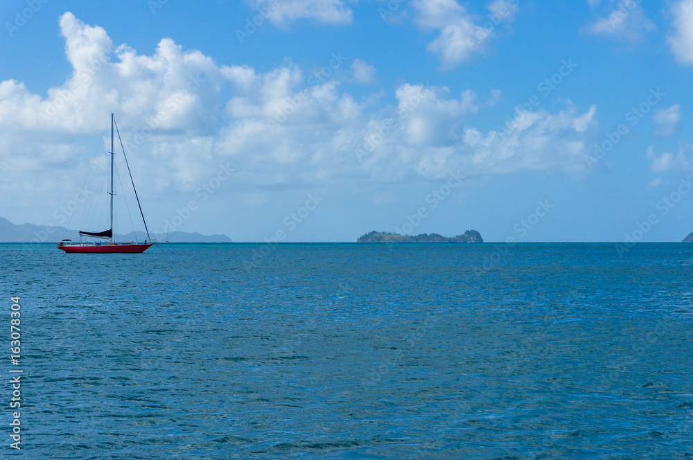 Obraz premium Red sailboat, yachts on calm sea