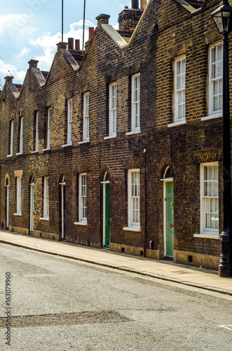 Typical English architecture, residential buildings in a row along the street photo