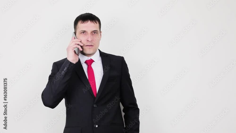 A man in a business suit with a phone A man in a business suit with a phone