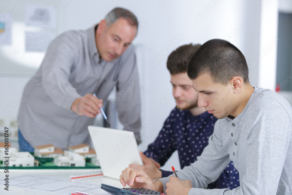 Fototapeta premium group of students working on construction project